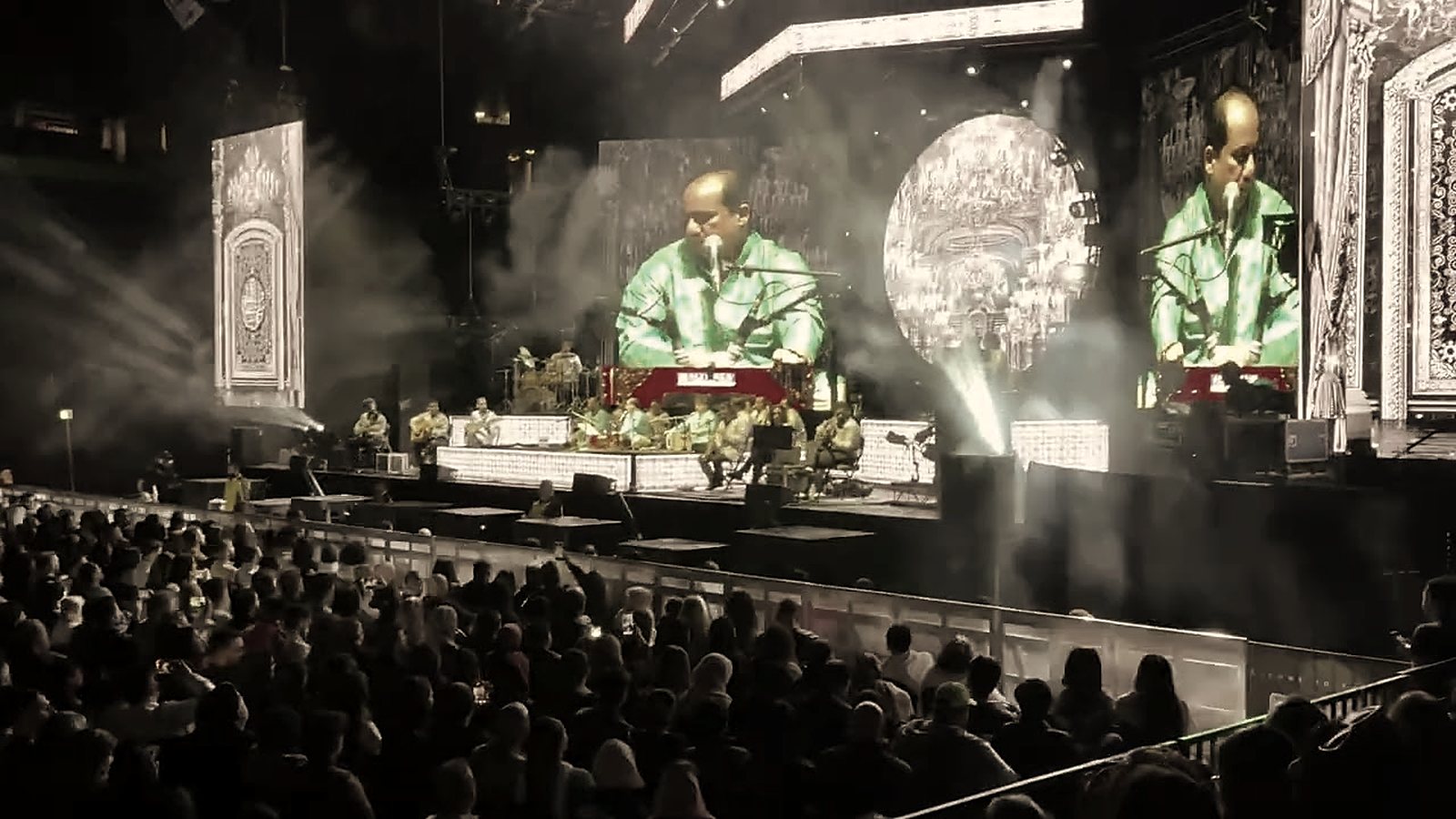 Rahat Fateh Ali Khan on stage at AO Arena, Manchester, with the arena crowd in front